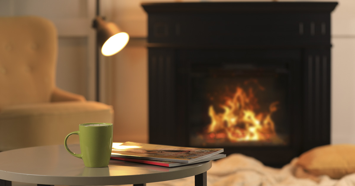 Cozy propane fireplace with a mug, providing warmth and comfort in a North or South Carolina home.